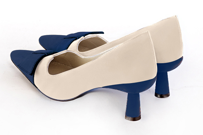 Navy blue and champagne beige women's dress pumps, with a knot on the front. Tapered toe. Medium spool heels. Rear view - Florence KOOIJMAN